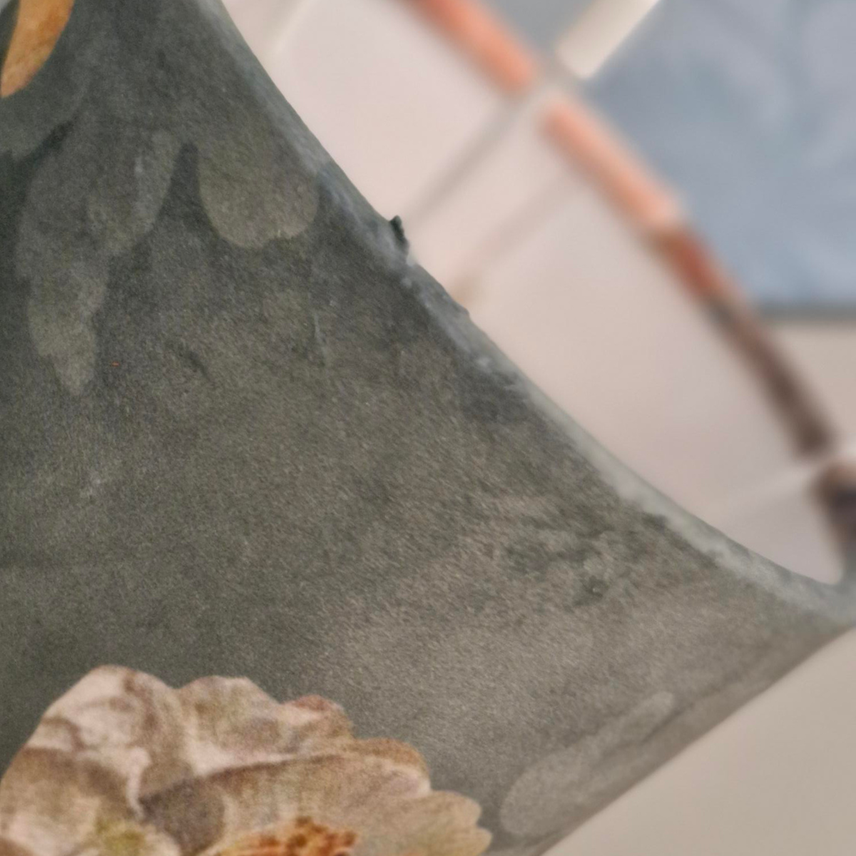 Close up showing the underside of a cylinder table lampshade showing the location of the short support legs.